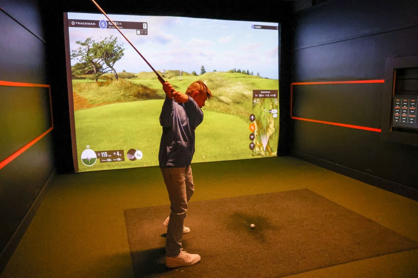 Kid playing the golf simulator