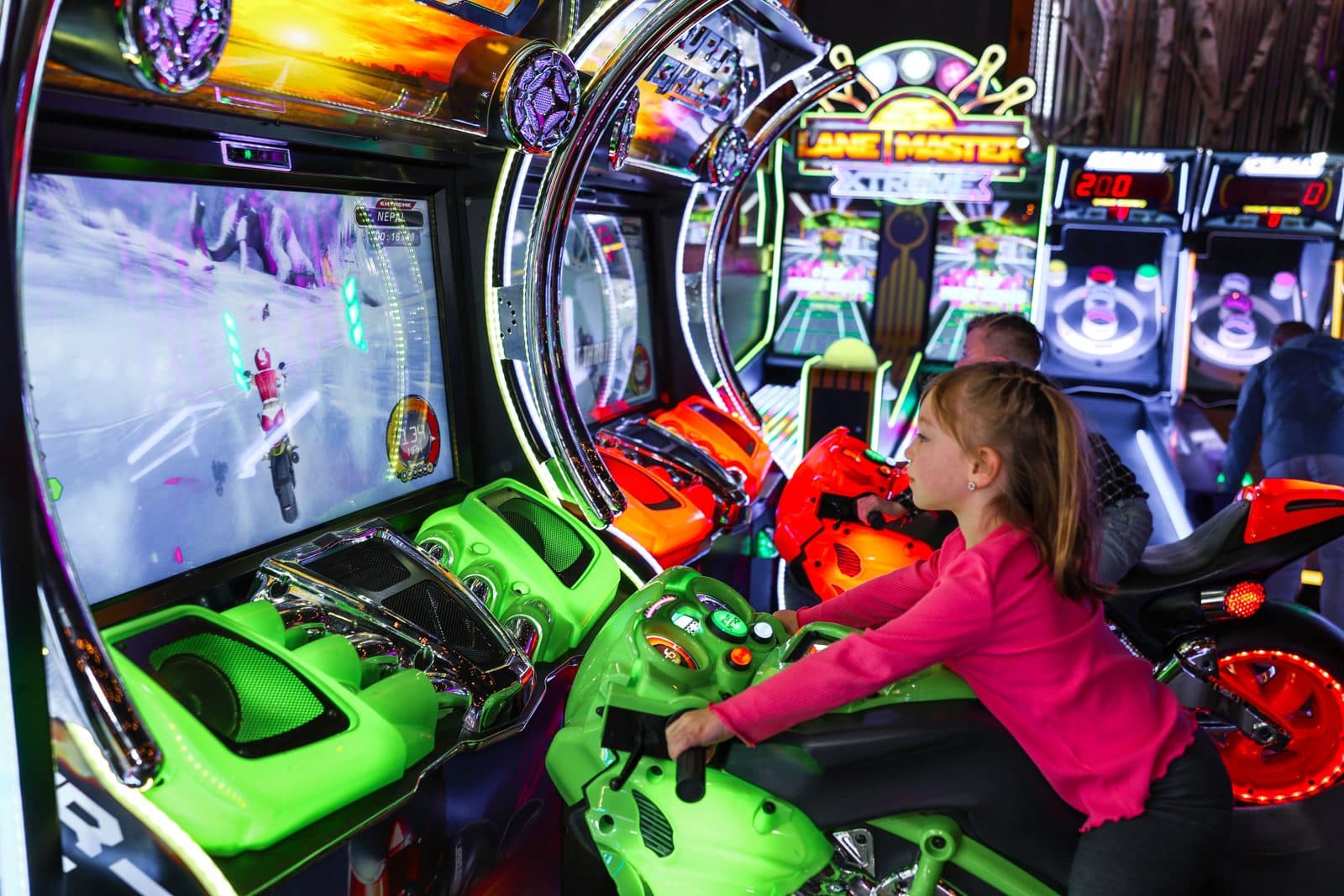 Kids racing on the arcade motorbikes