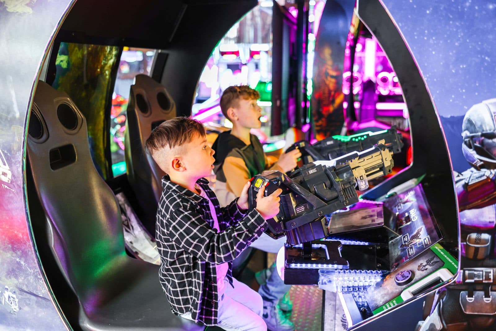 Kid in the arcade racing pod